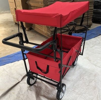 Os carros dobráveis do carro dobrável vermelho do vagão com rodas cobrem o punho do impulso